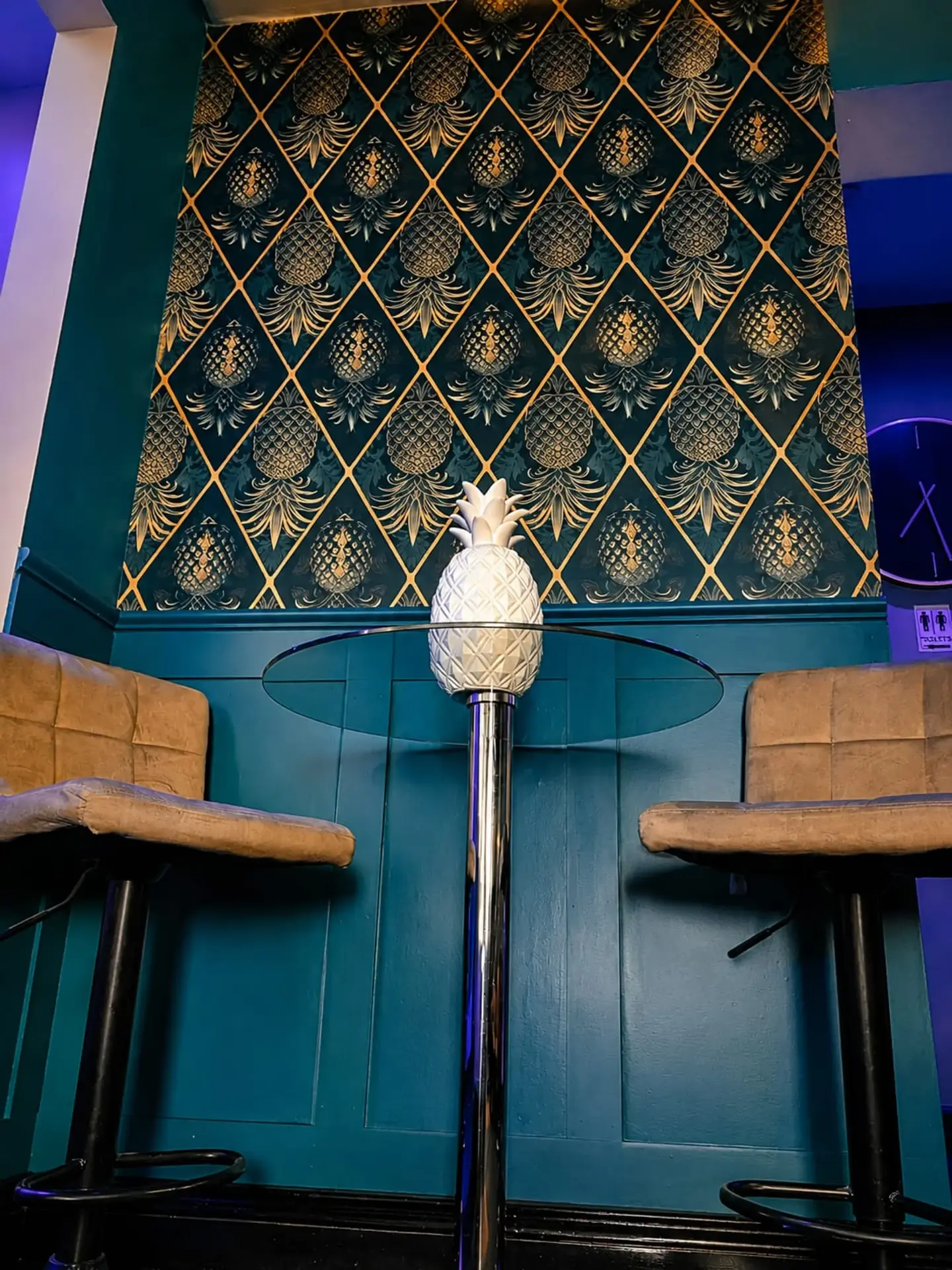 A turquoise and gold seating nook inside PDI Birmingham